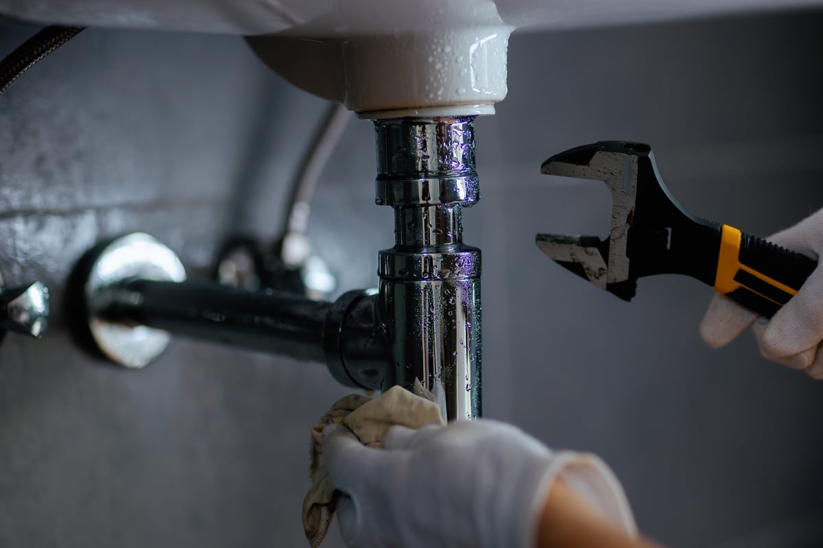 Professional plumbing repair under sink